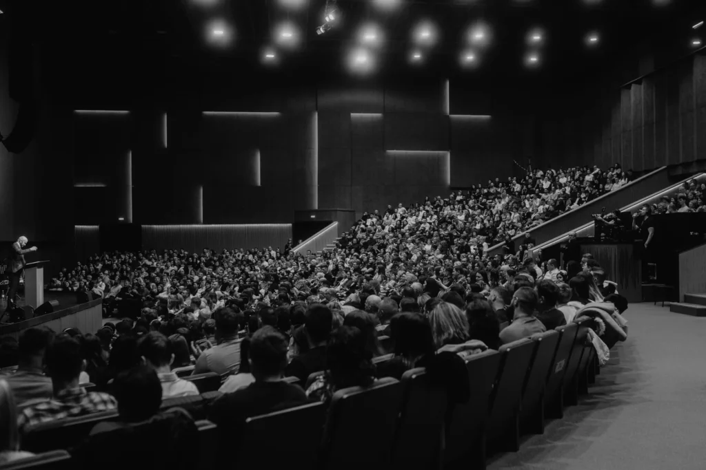 Large audience seated in a conference auditorium