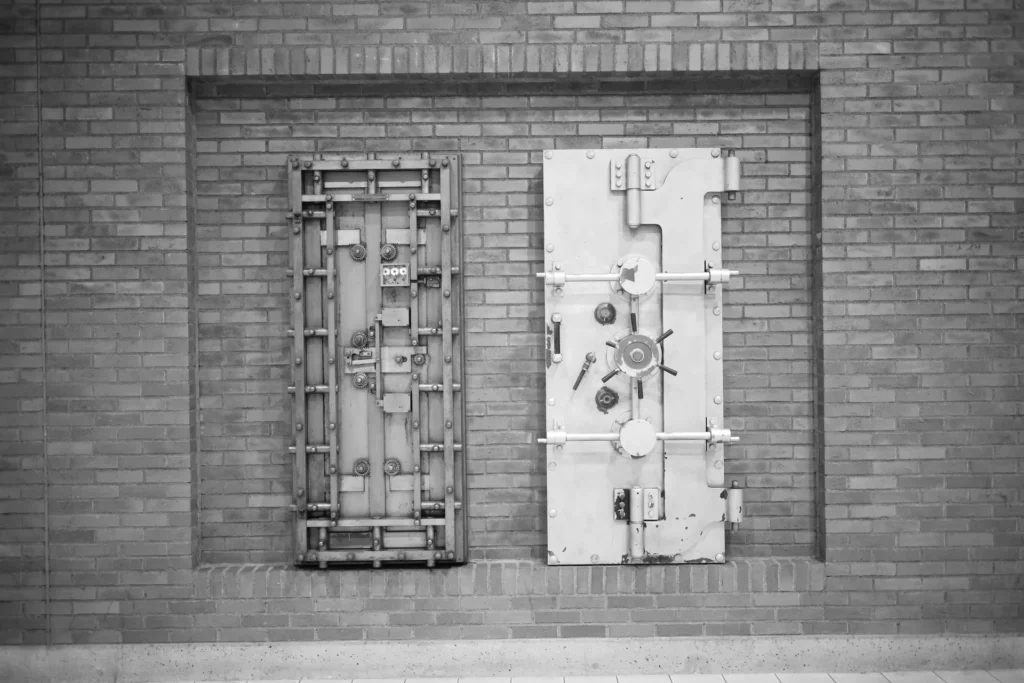 Steel bank vault doors set into a brick wall