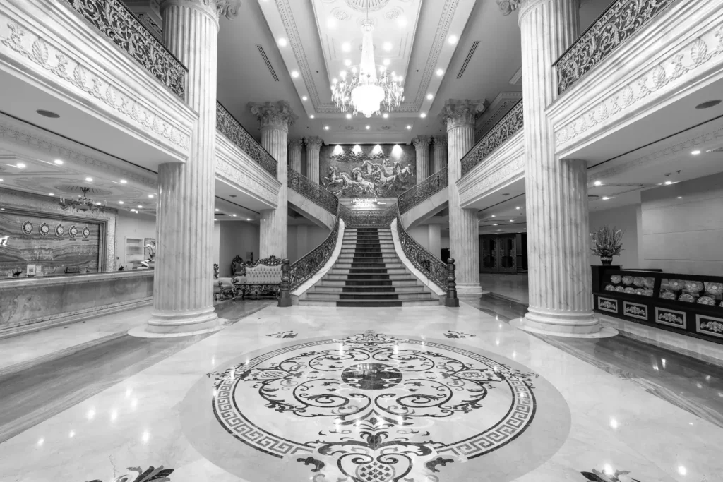 Grand hotel foyer with marble floor and staircase