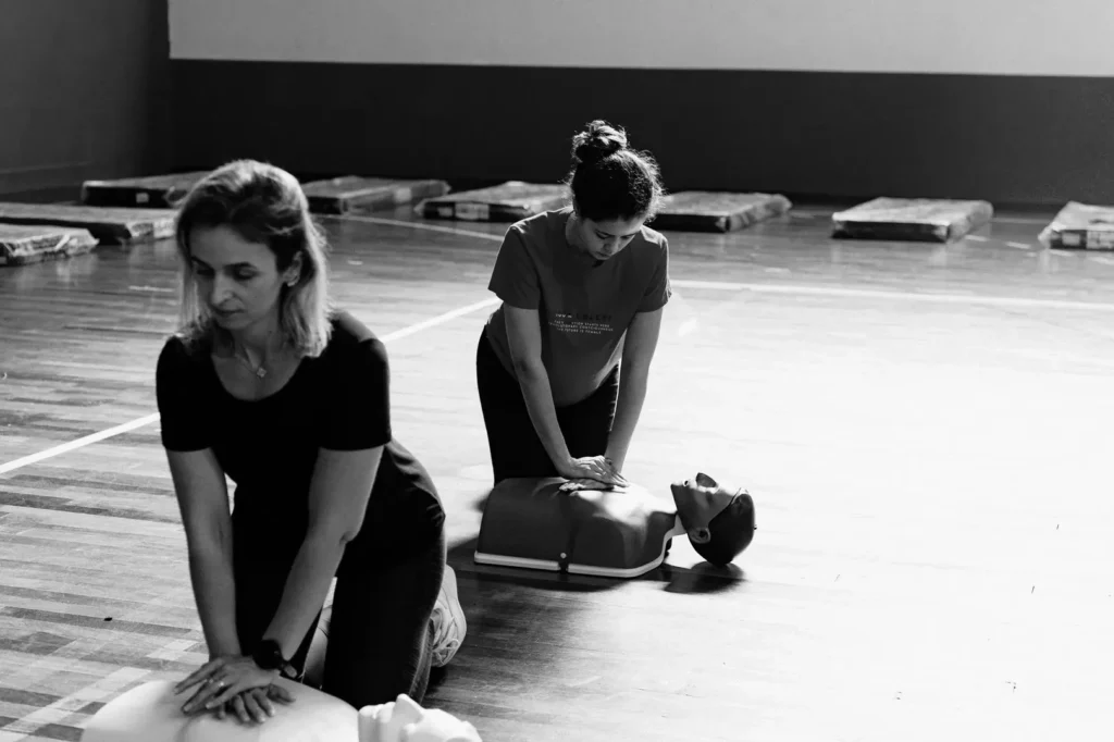 Trainees practising CPR on mannequins during a training session